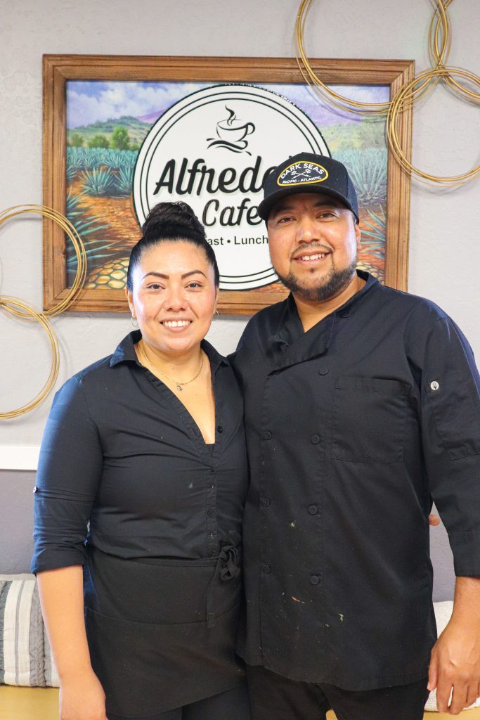 Woman and man in black clothing smiling